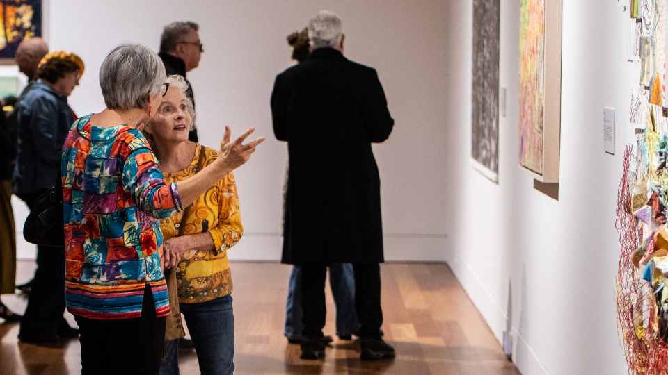 CAM group of people looking at artwork in the gallery
